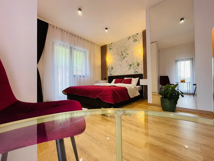 Botanical bedroom seen from the hallway with glass balustrade